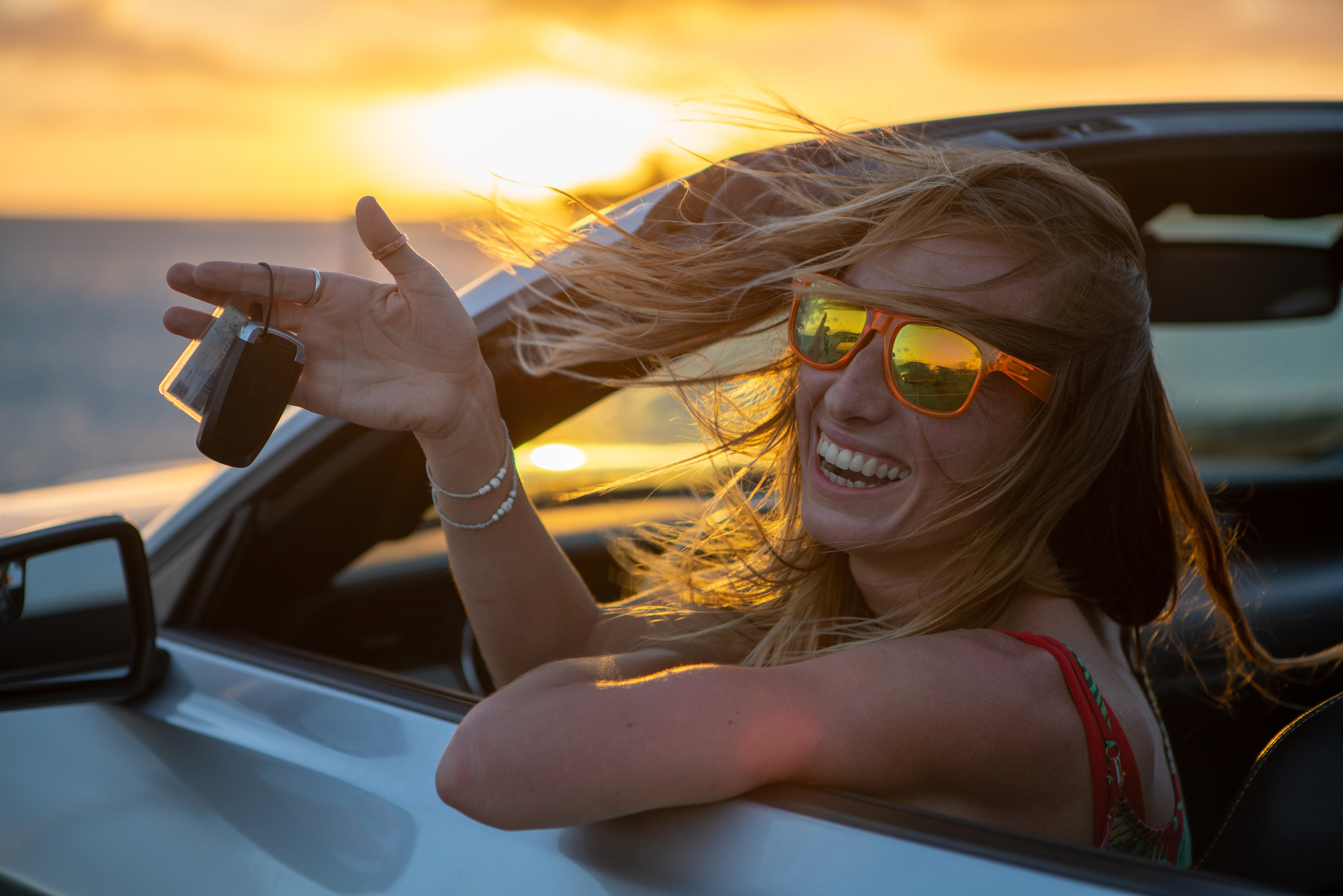 Young woman renting a car in Hawaii